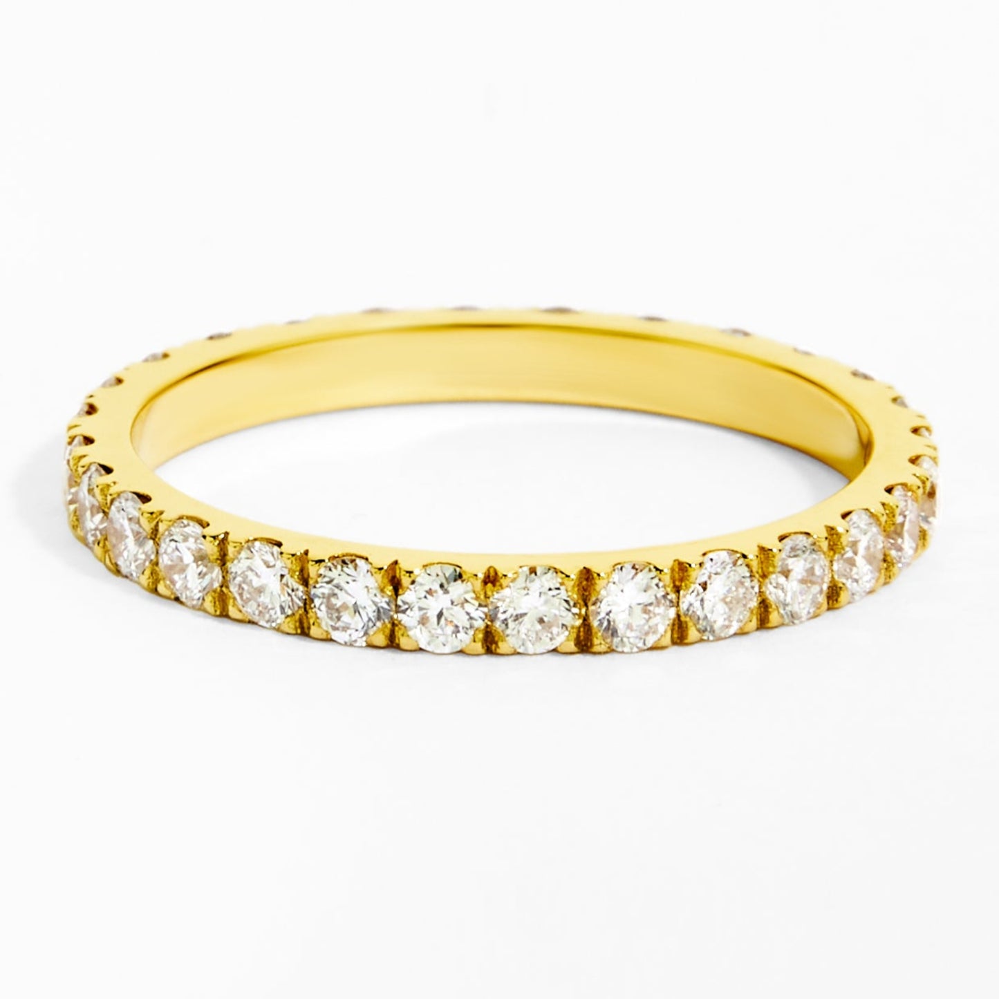 Gold ring with small diamonds on a white background