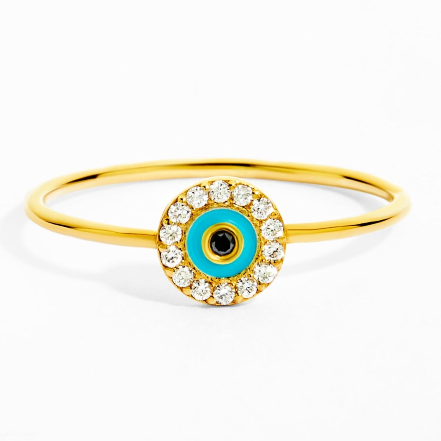 Gold ring with a blue eye design on a white background
