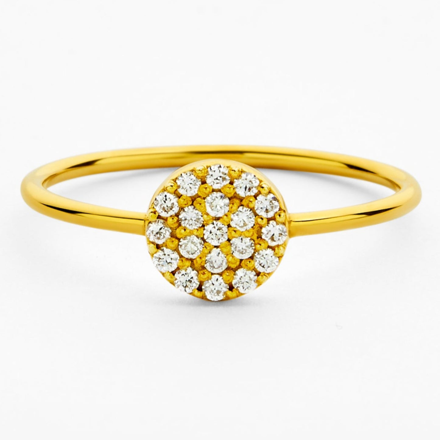 Gold ring with a circular diamond pavé design on a white background