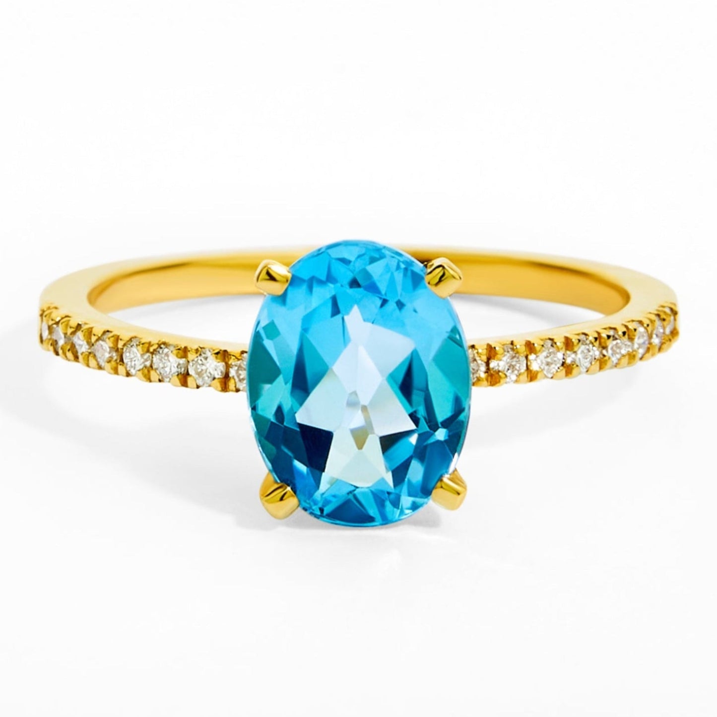 Gold ring with a blue gemstone on a white background