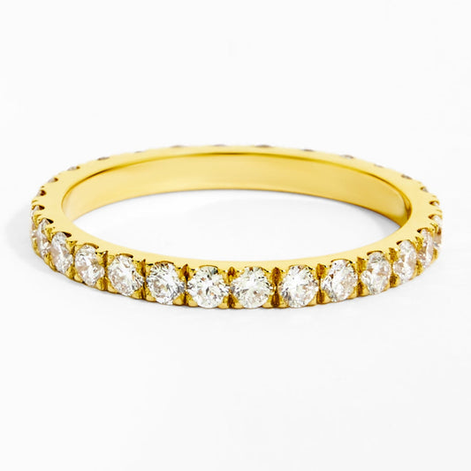 Gold ring with small diamonds on a white background