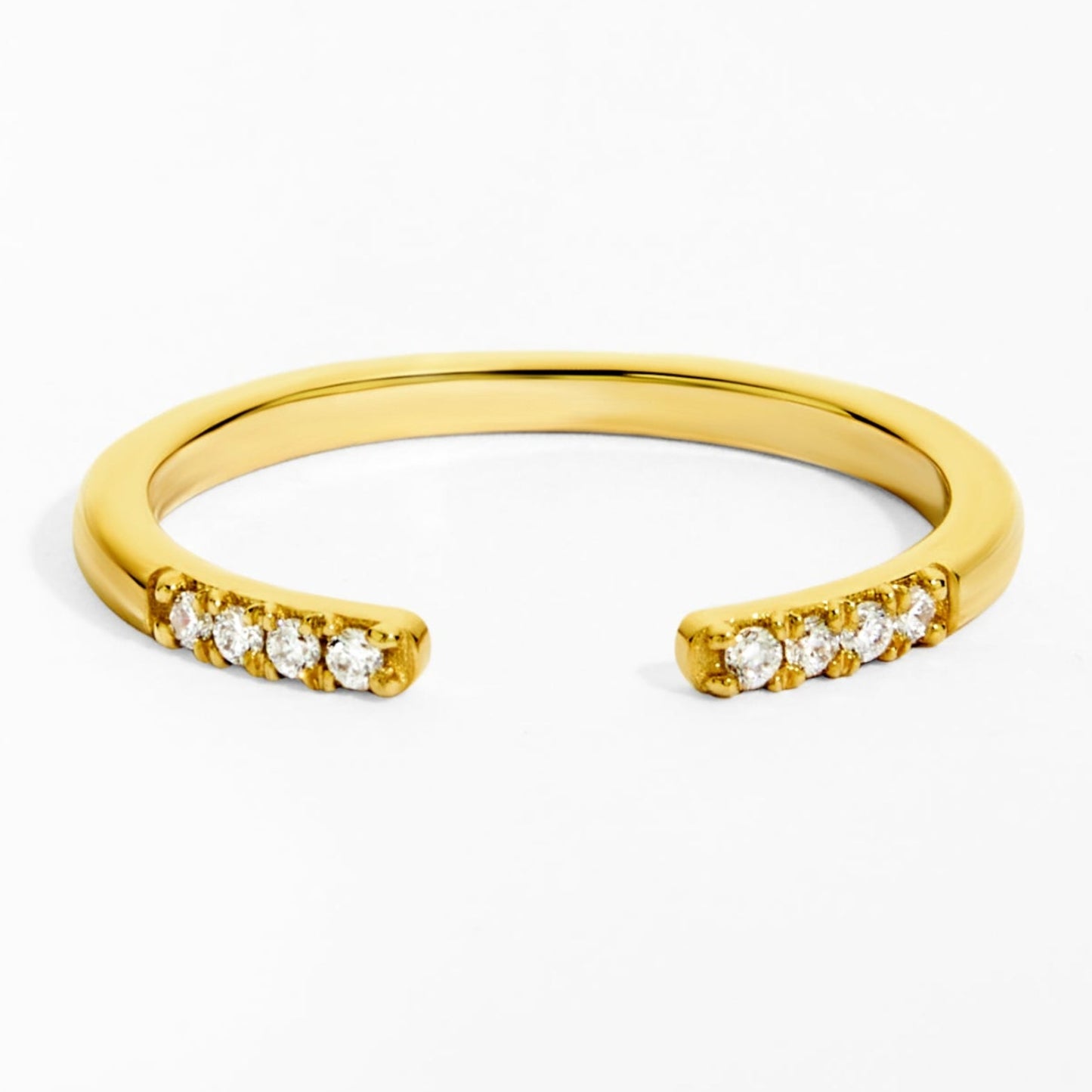 Gold ring with small diamonds on a white background