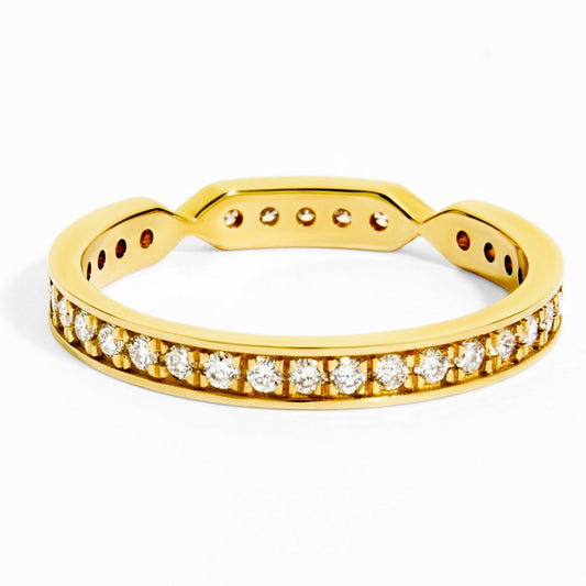 Gold ring with diamond accents on a white background