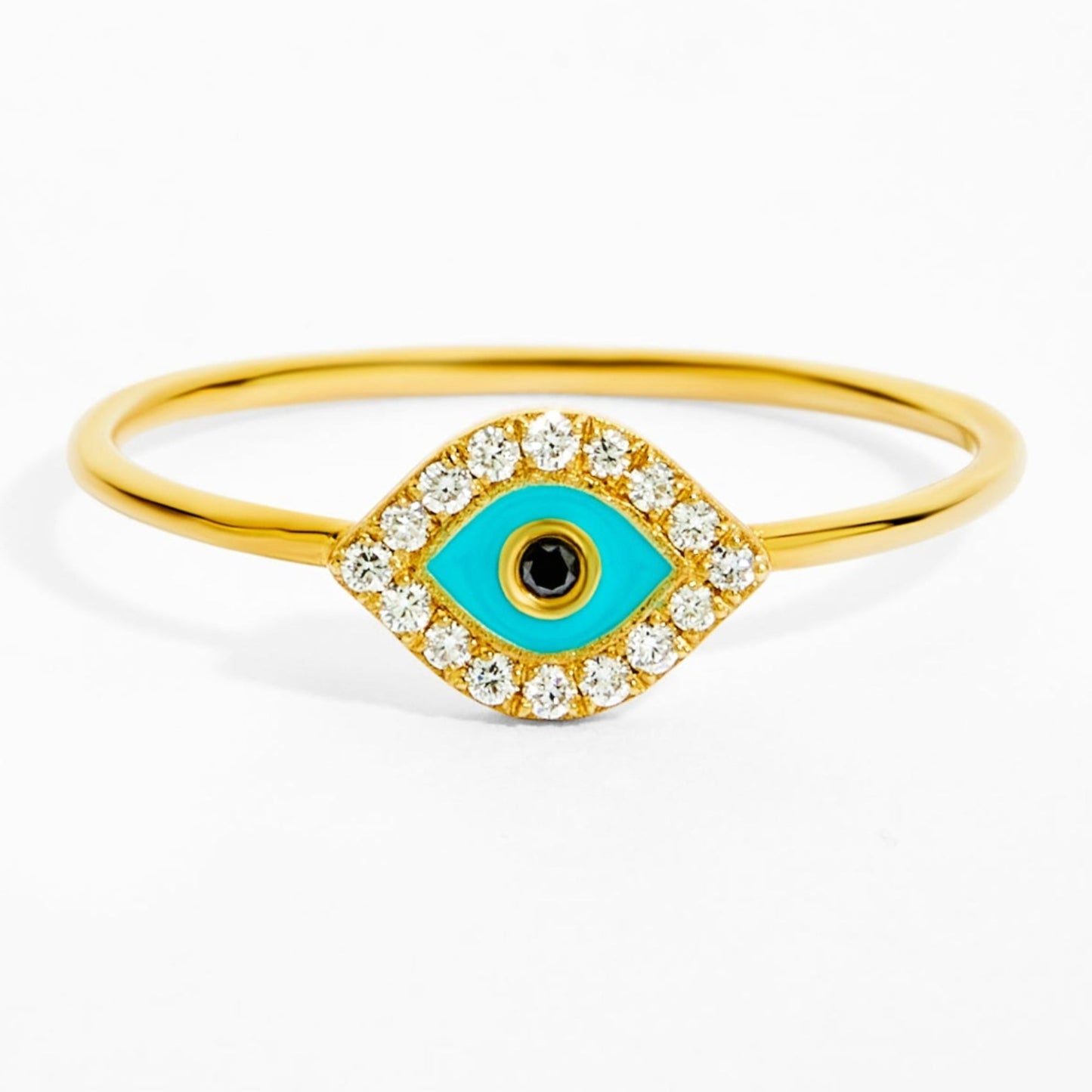 Gold ring with a turquoise evil eye design on a white background