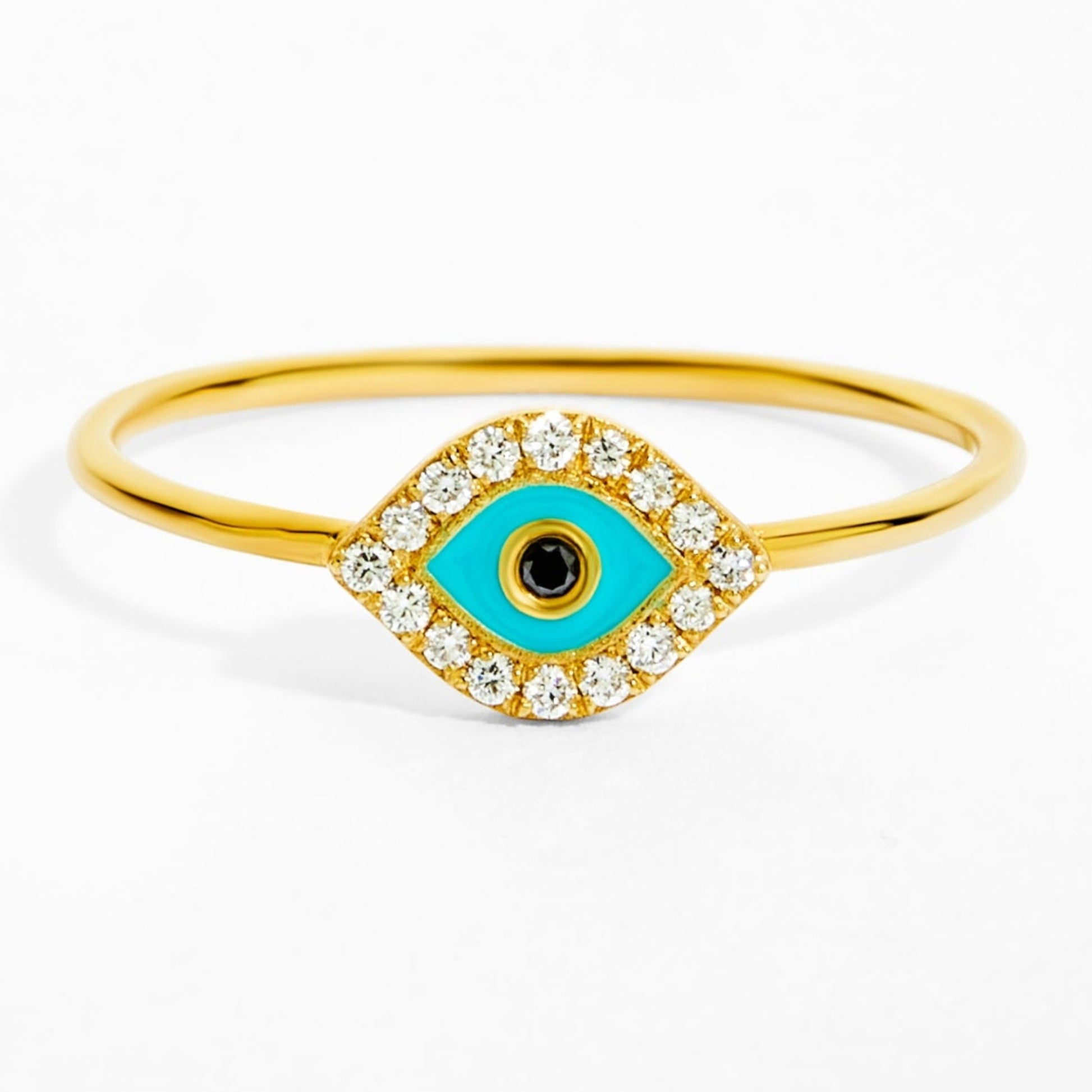 Gold ring with a turquoise evil eye design on a white background