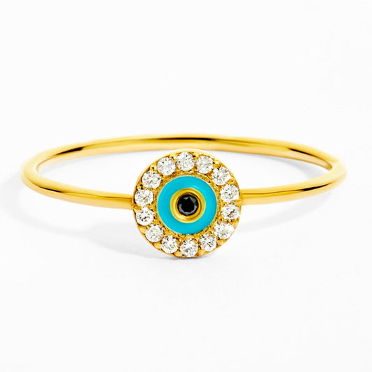 Gold ring with a blue eye design on a white background