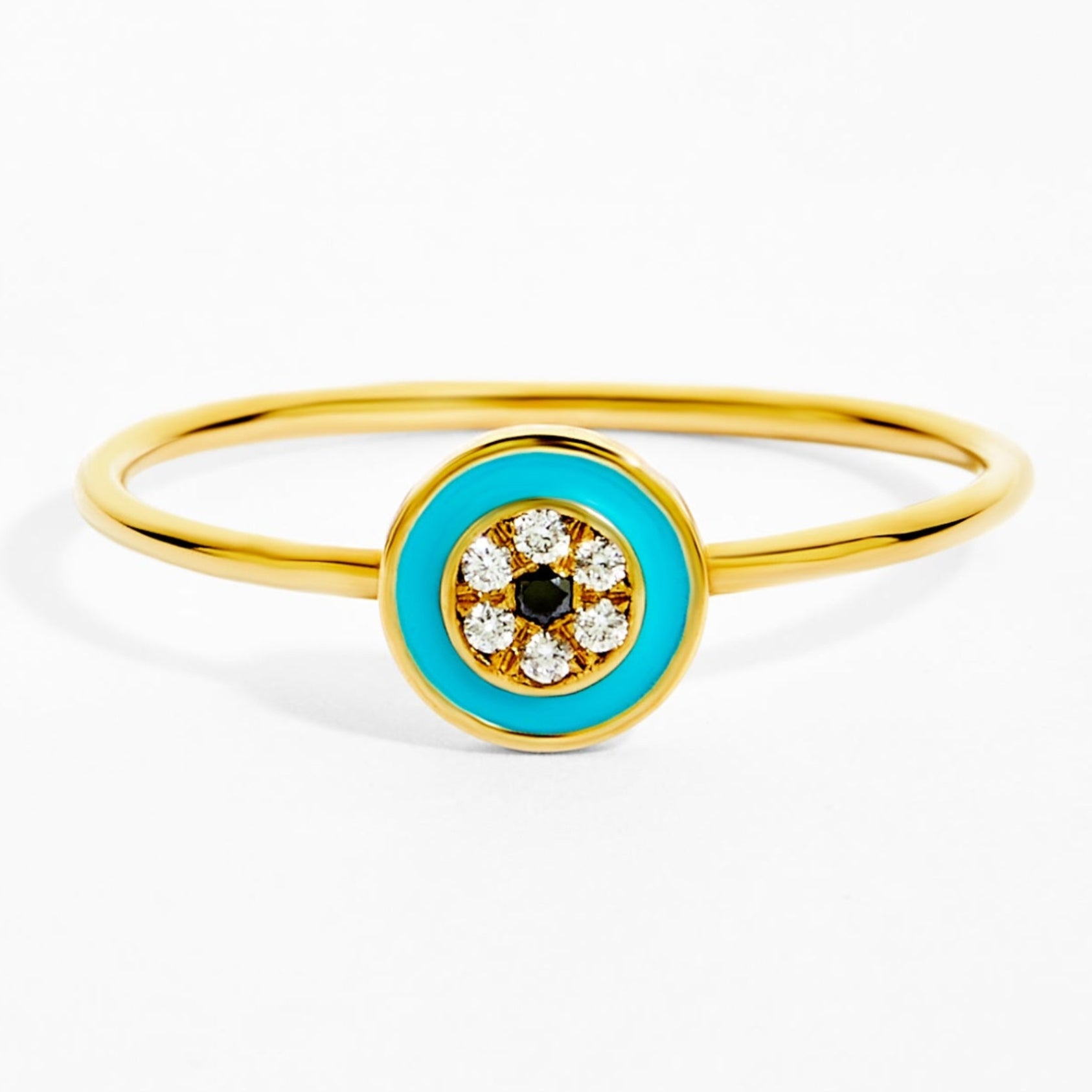 Gold ring with a blue Evil Eye design on a white background