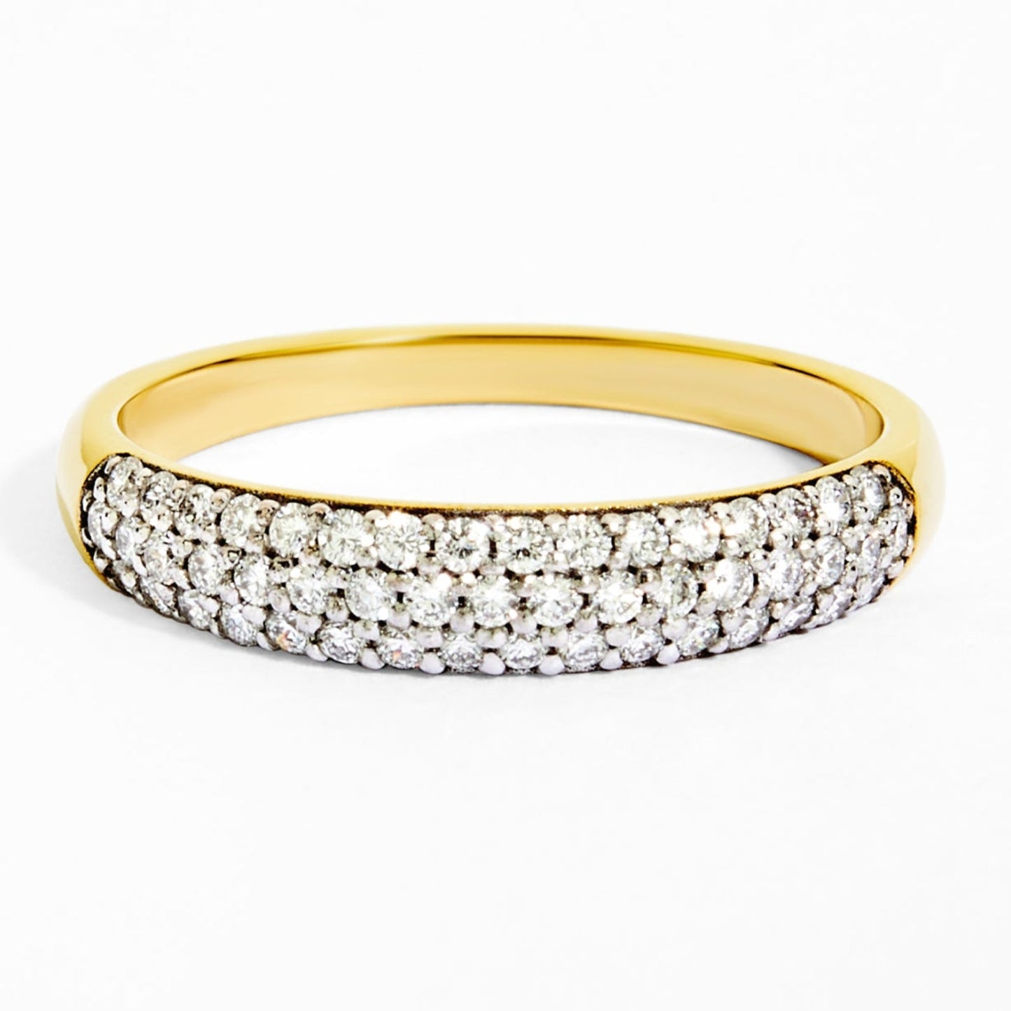 Gold ring with embedded diamonds on a white background