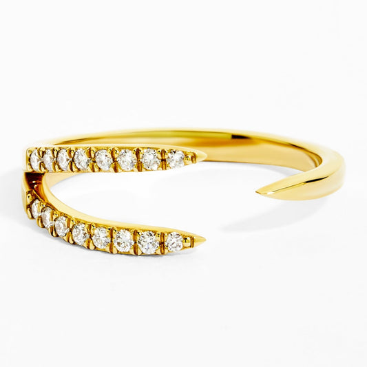 Gold ring with diamond accents on a white background