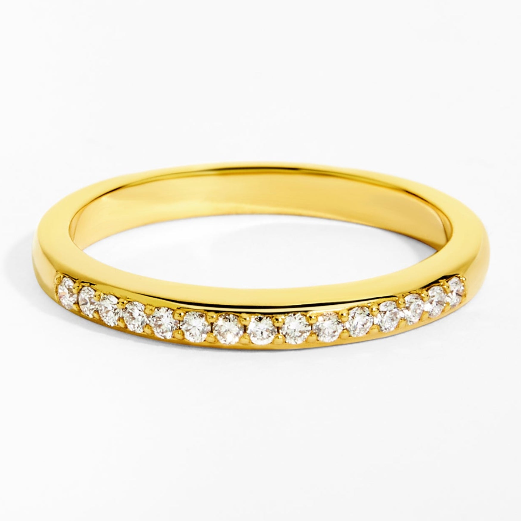 Gold ring with small diamonds on a white background
