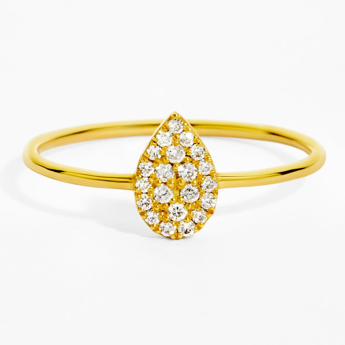 Gold ring with a teardrop-shaped diamond design on a white background