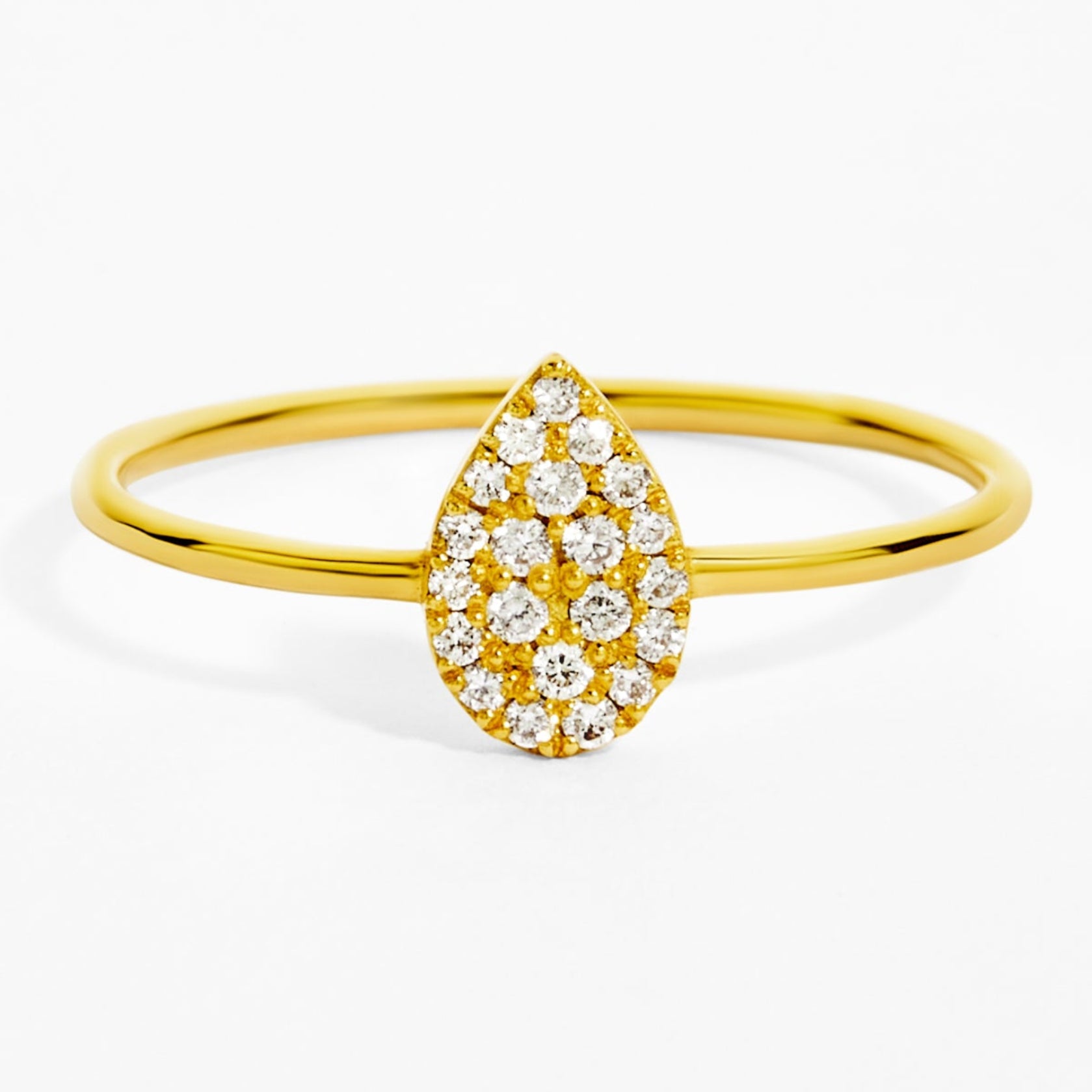 Gold ring with a teardrop-shaped diamond design on a white background