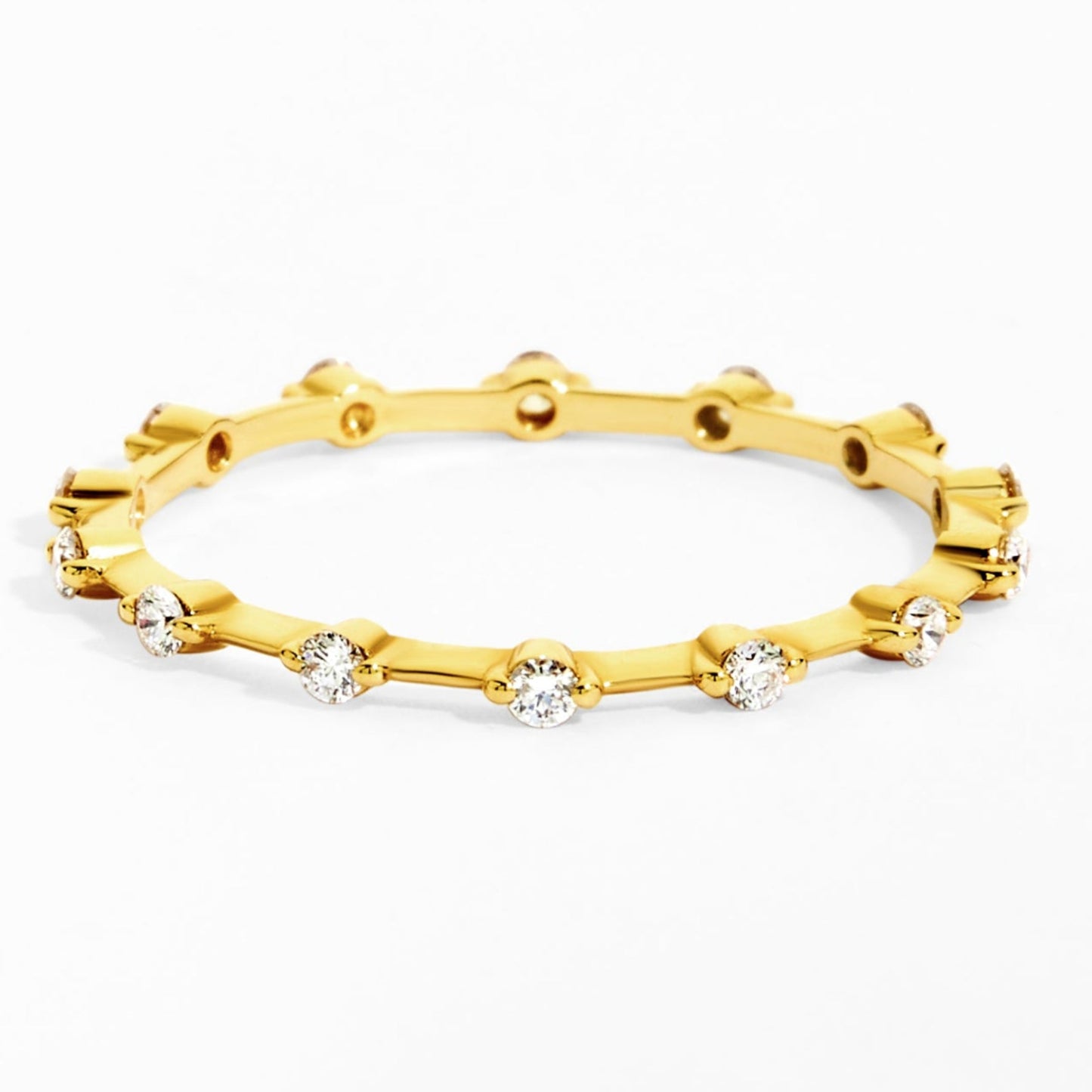 Gold ring with embedded diamonds on a white background