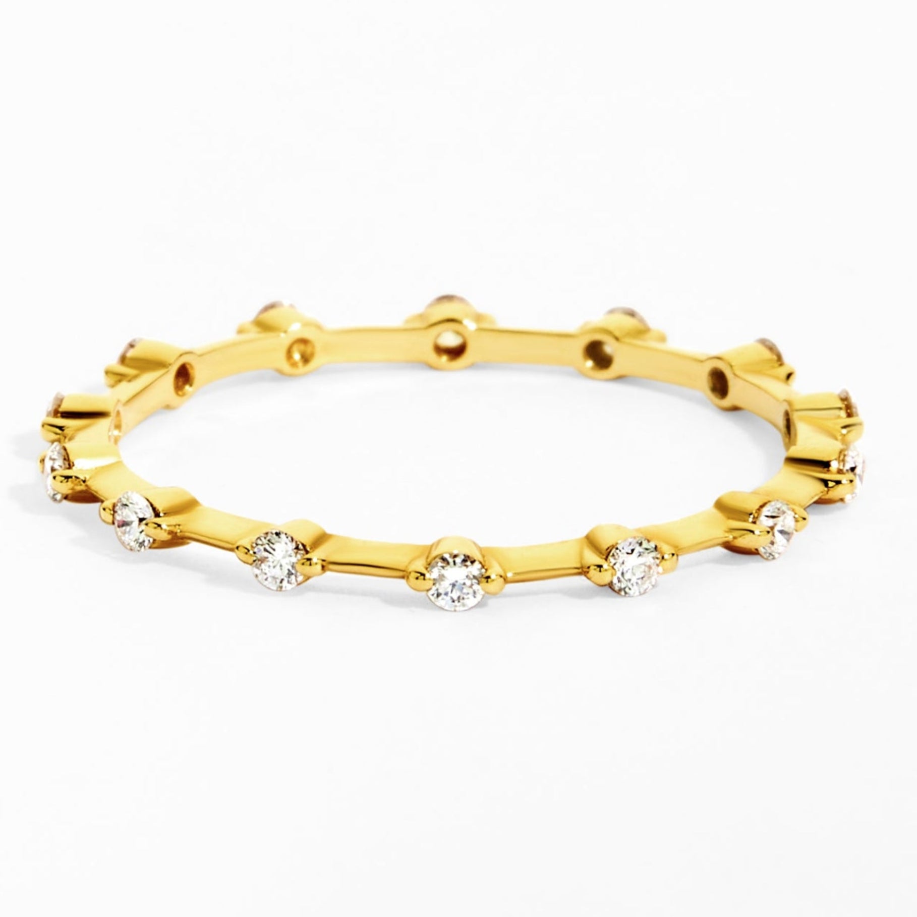 Gold ring with embedded diamonds on a white background