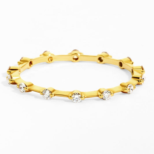 Gold ring with embedded diamonds on a white background