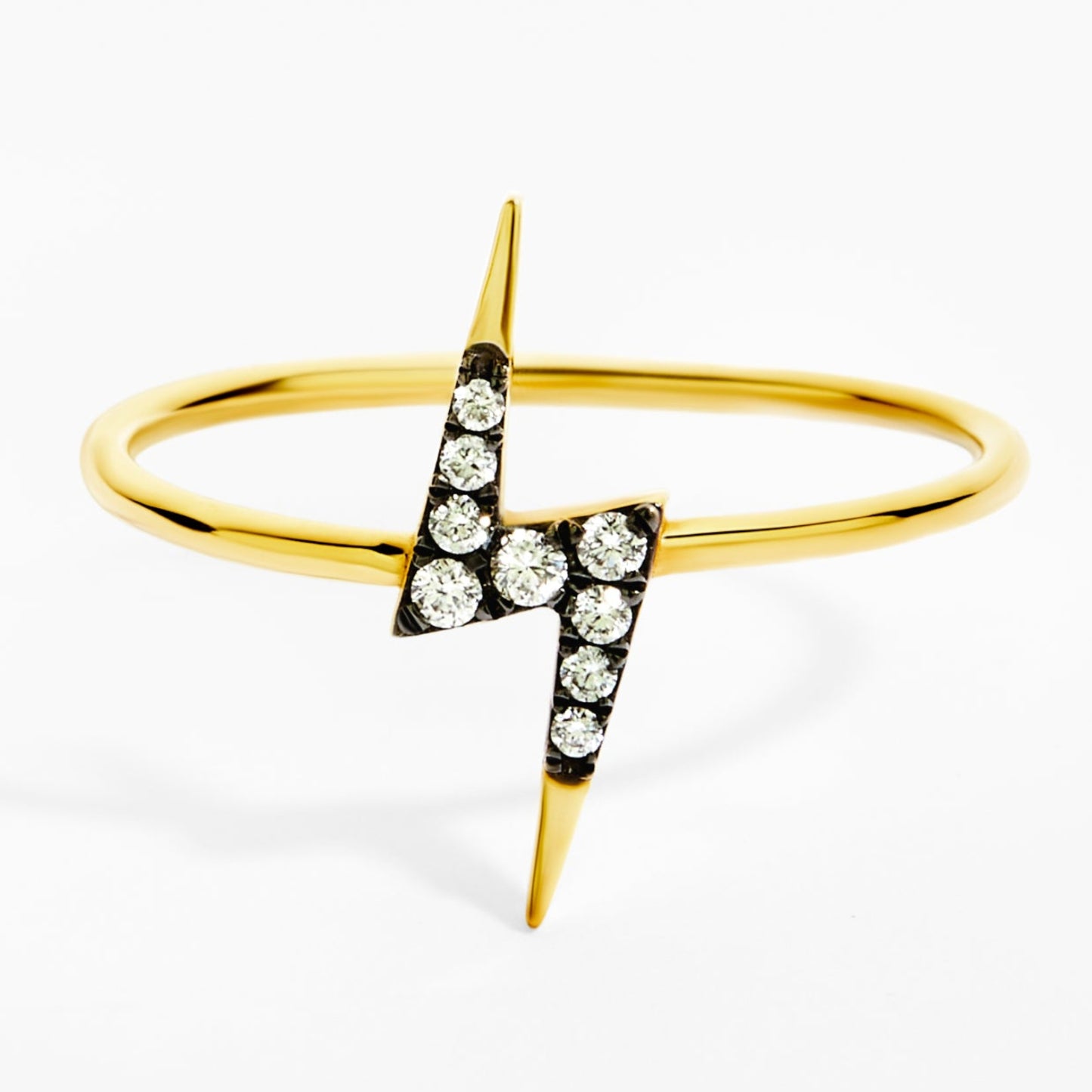 Gold ring with a lightning bolt design on a white background