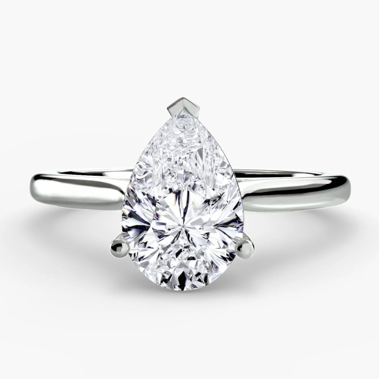 Pear-shaped diamond ring on a white background