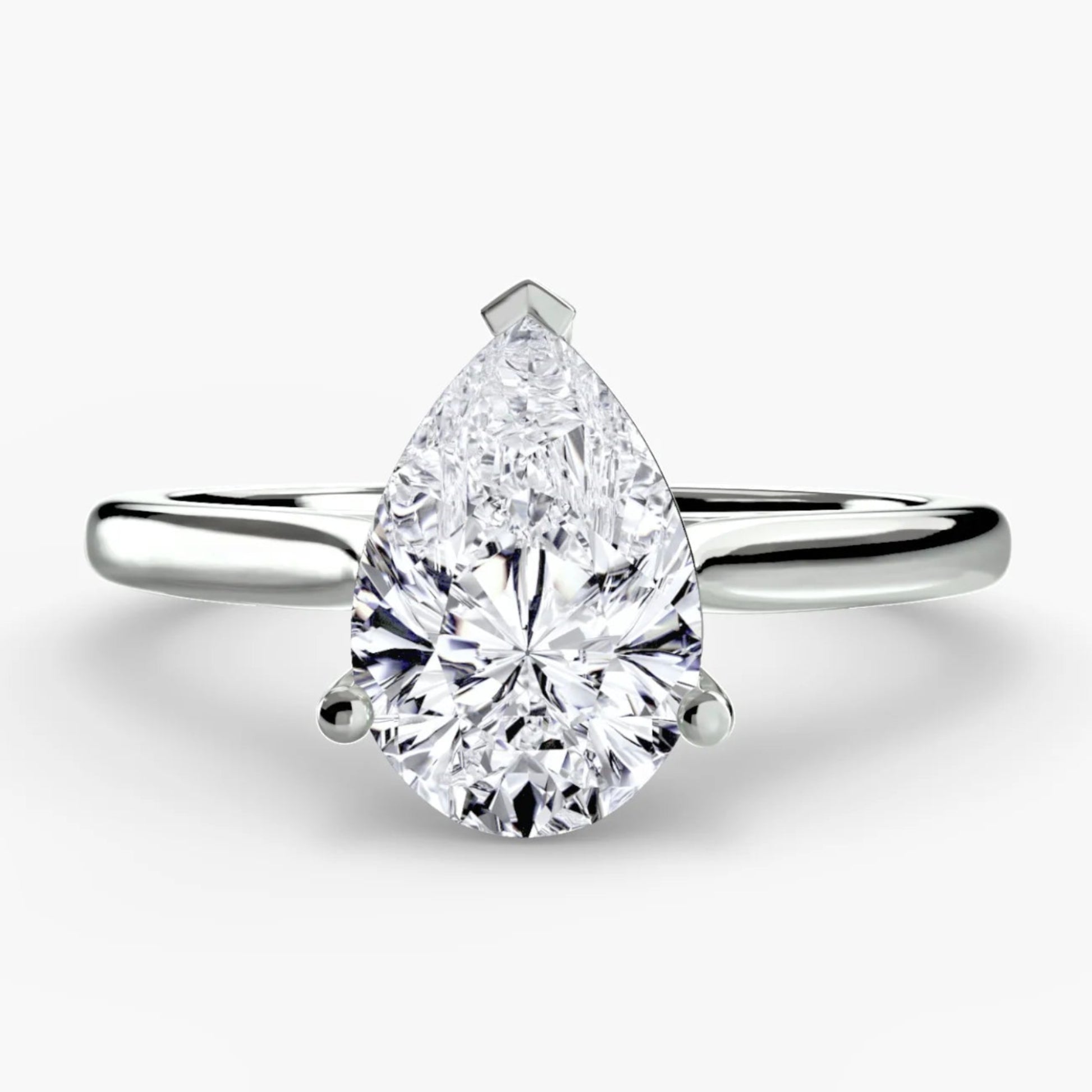 Pear-shaped diamond ring on a white background