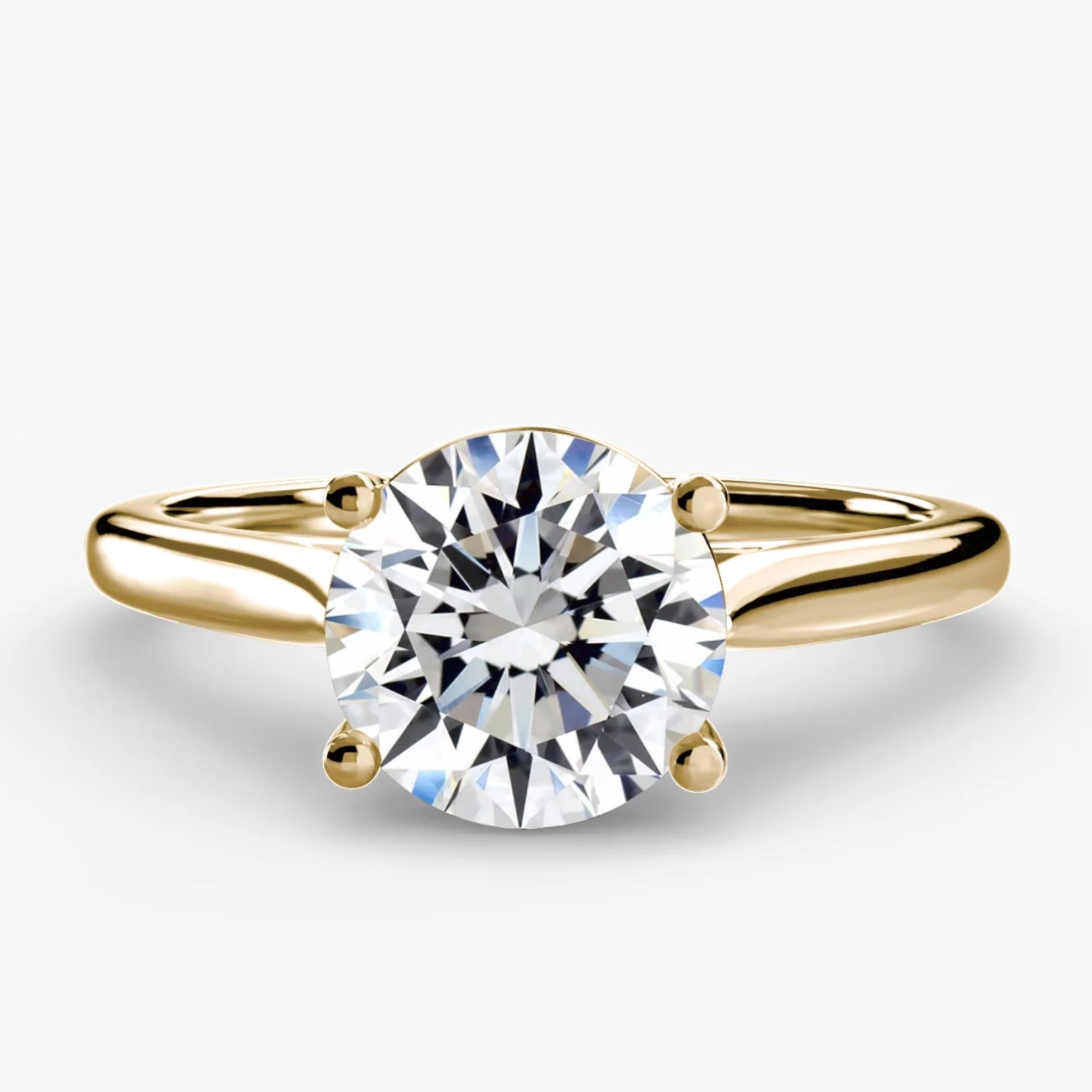 Gold ring with a diamond on a white background