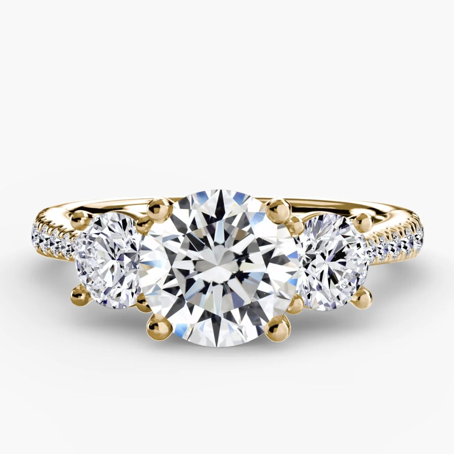 Gold ring with three diamonds on a white background