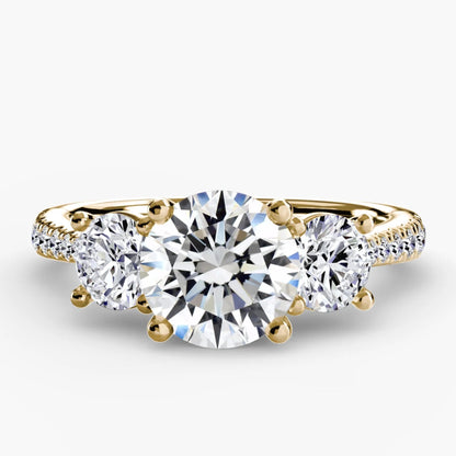 Gold ring with three diamonds on a white background