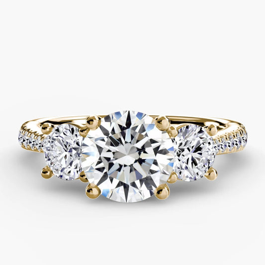 Gold ring with three diamonds on a white background