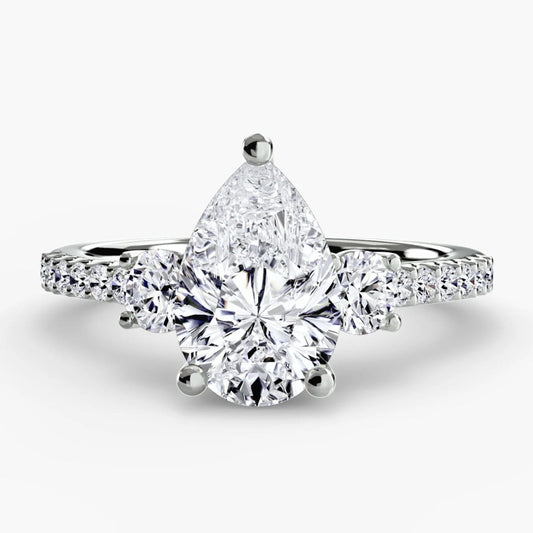 Diamond ring with a pear-shaped center stone on a white background