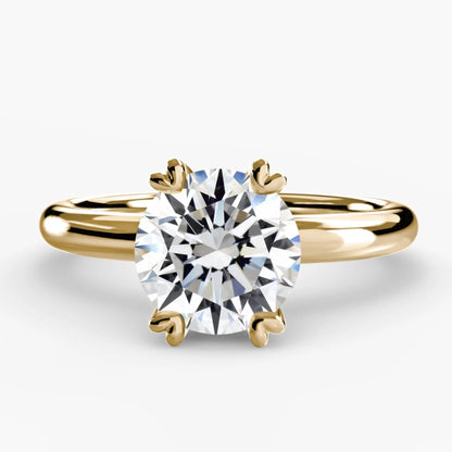 Gold ring with a diamond on a white background
