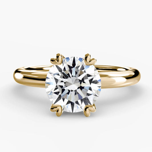 Gold ring with a diamond on a white background