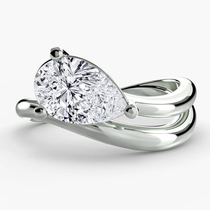 Silver ring with a pear-shaped diamond on a white background