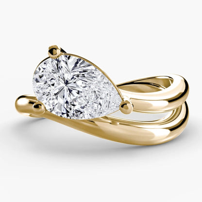 Gold ring with a large diamond on a white background
