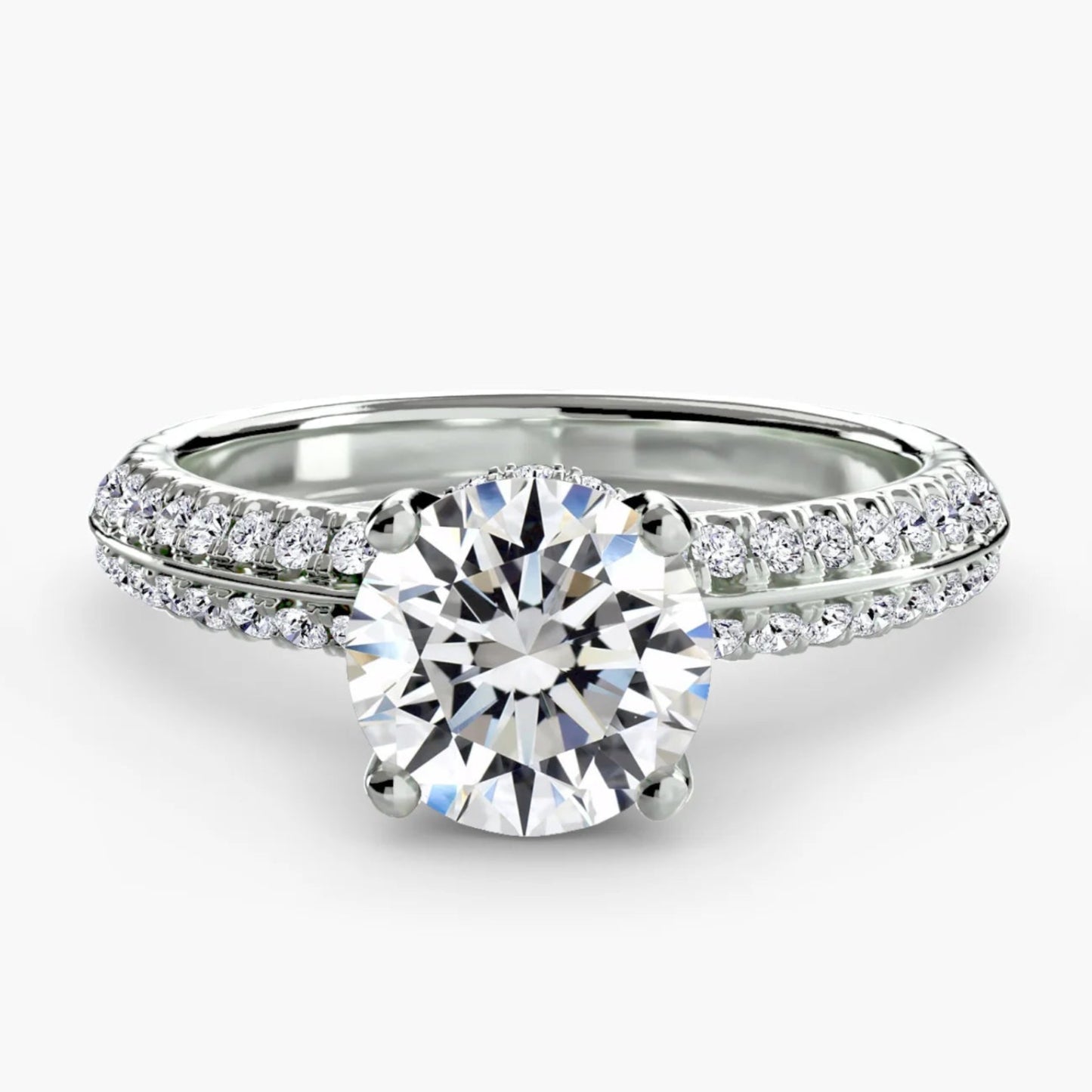 Silver ring with a large diamond and smaller diamonds on the band against a white background