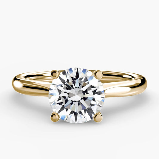 Gold ring with a diamond on a white background
