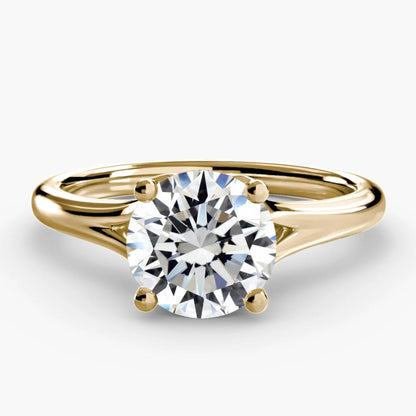 Gold ring with a diamond on a white background