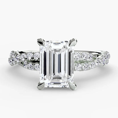 Diamond ring with emerald-cut center stone on a white background