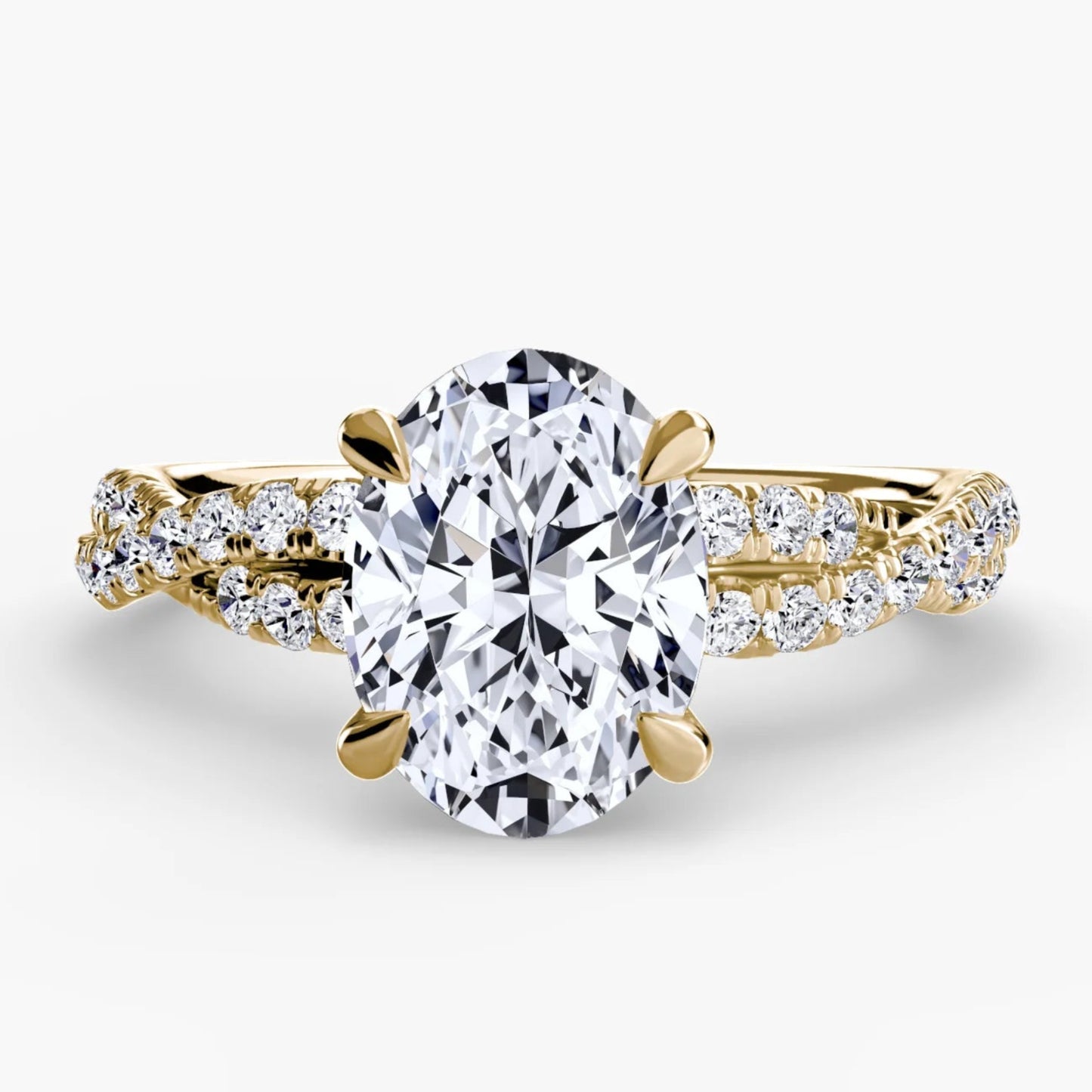 Gold ring with a large diamond and smaller diamonds on the band against a white background