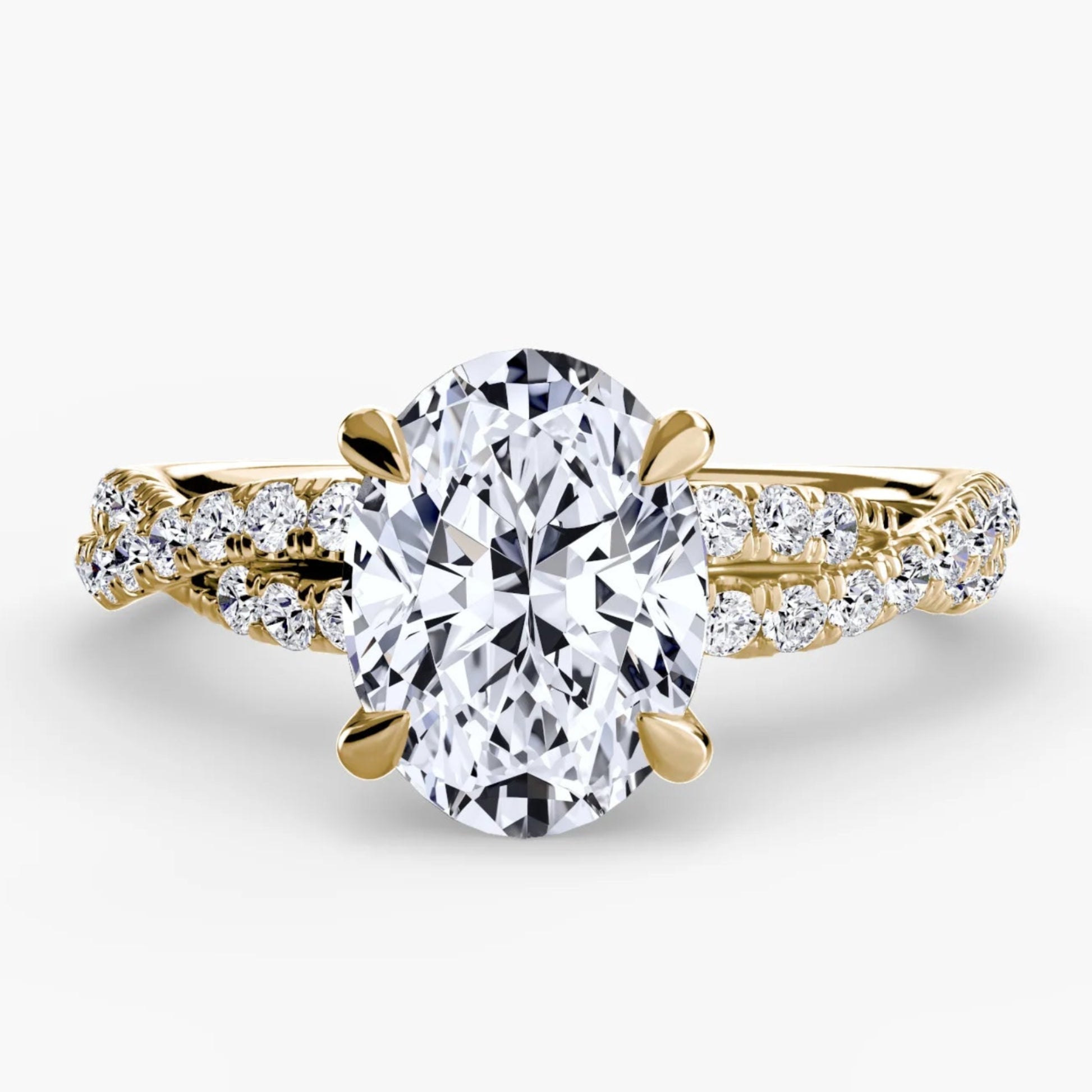 Gold ring with a large diamond and smaller diamonds on the band against a white background