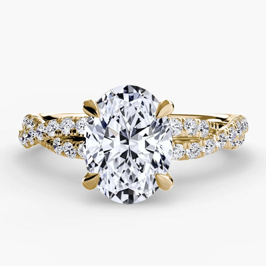 Gold ring with a large diamond and smaller diamonds on the band against a white background