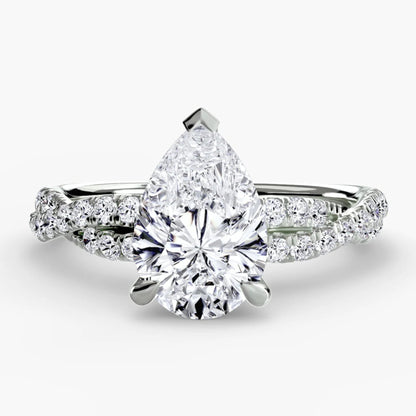 Diamond ring with pear-shaped center stone on a white background
