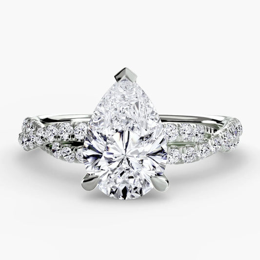 Diamond ring with pear-shaped center stone on a white background