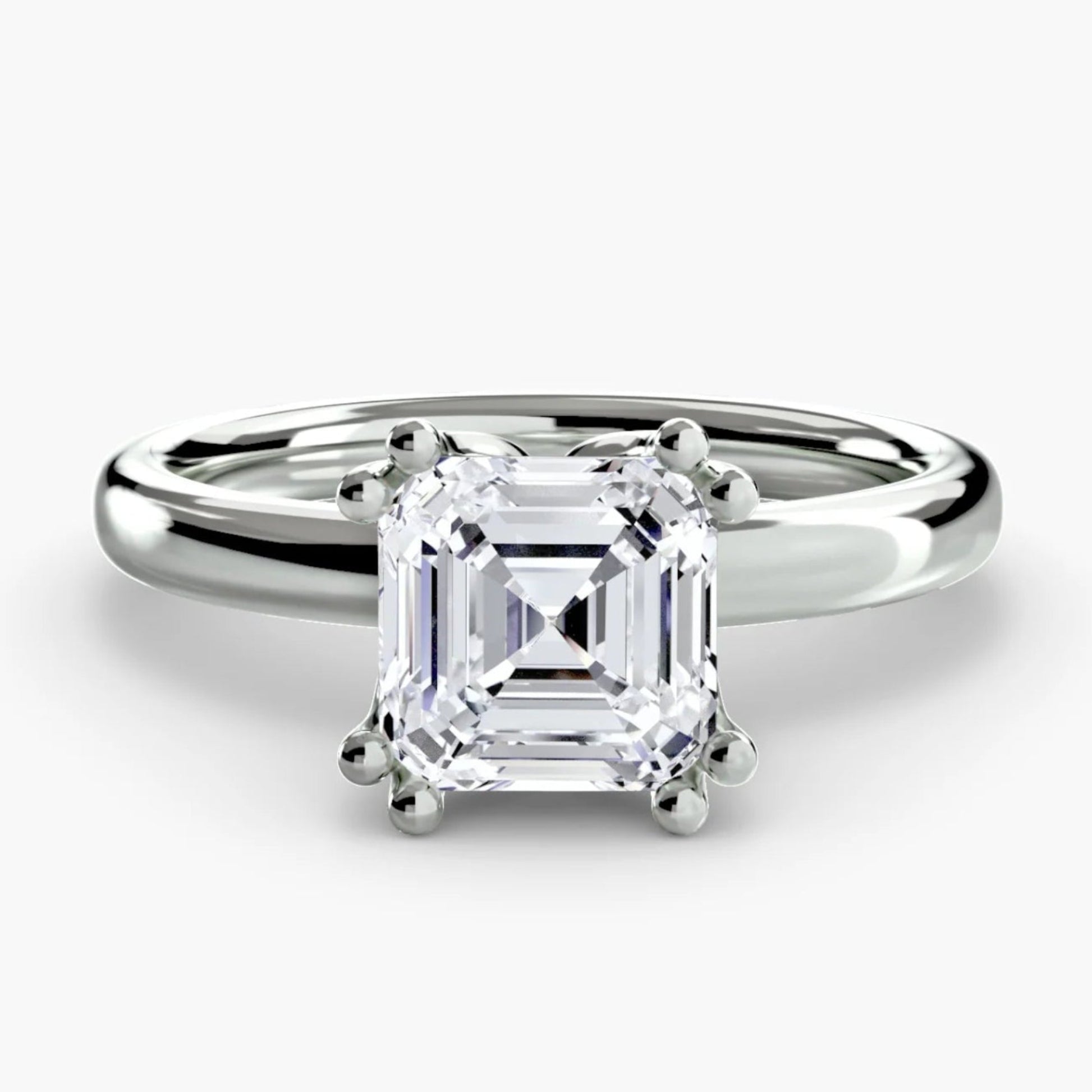 Diamond ring with a white gemstone on a light gray background
