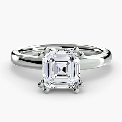 Diamond ring with a white gemstone on a light gray background