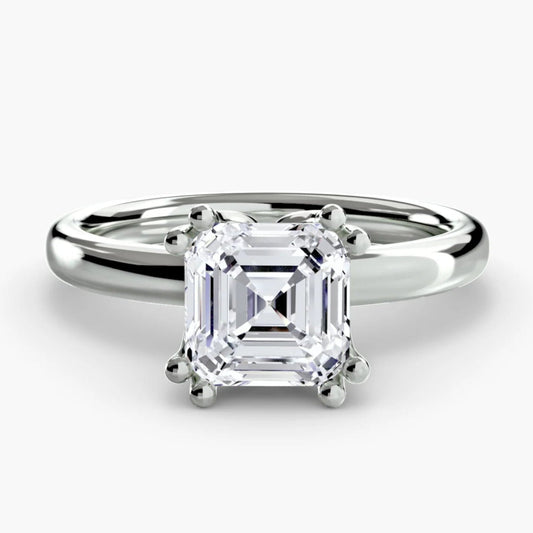 Diamond ring with a white gemstone on a light gray background