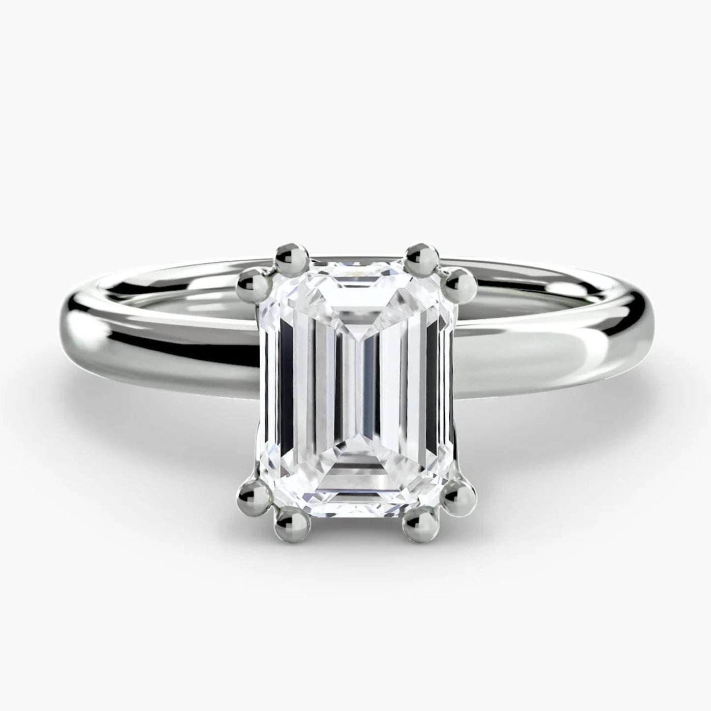 Diamond ring with emerald-cut gemstone on a white background