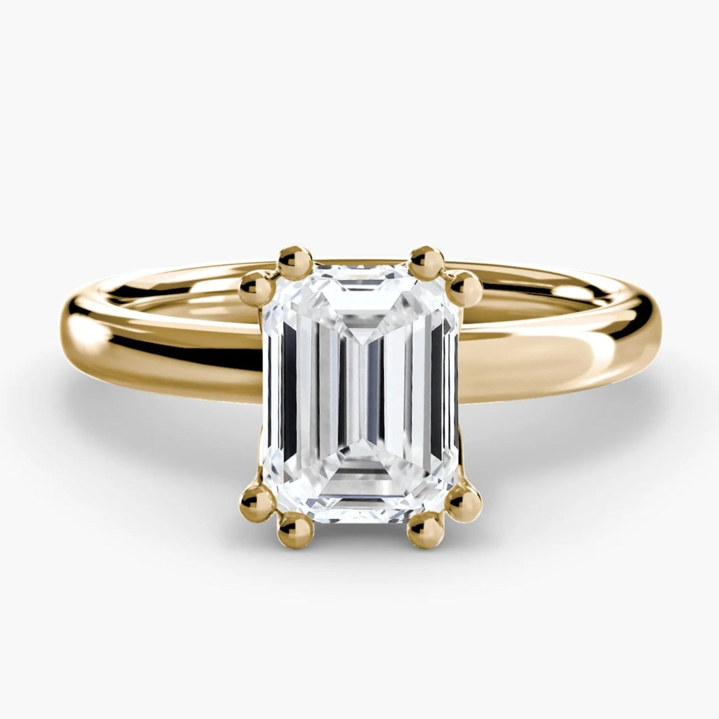 Gold ring with a large diamond on a white background