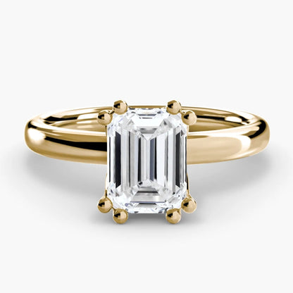 Gold ring with a large diamond on a white background