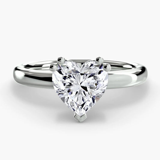 Diamond ring with a heart-shaped gemstone on a white background