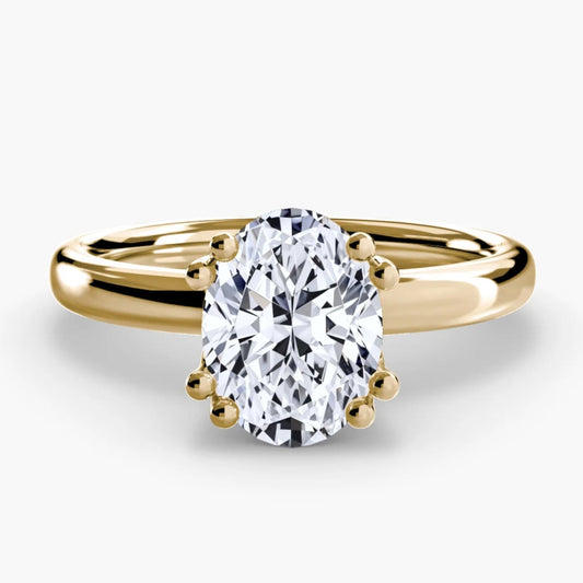 Gold ring with a large diamond on a white background
