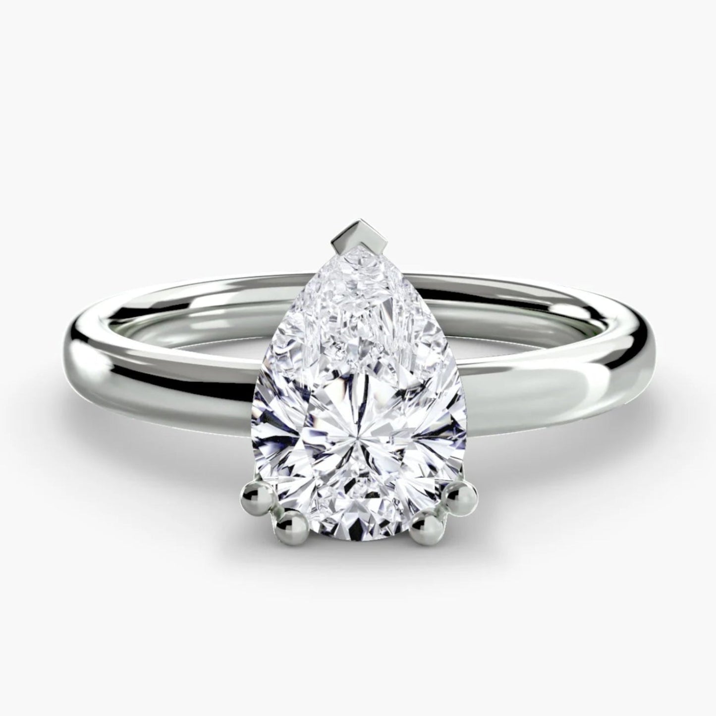 Diamond ring with pear-shaped gemstone on a white background