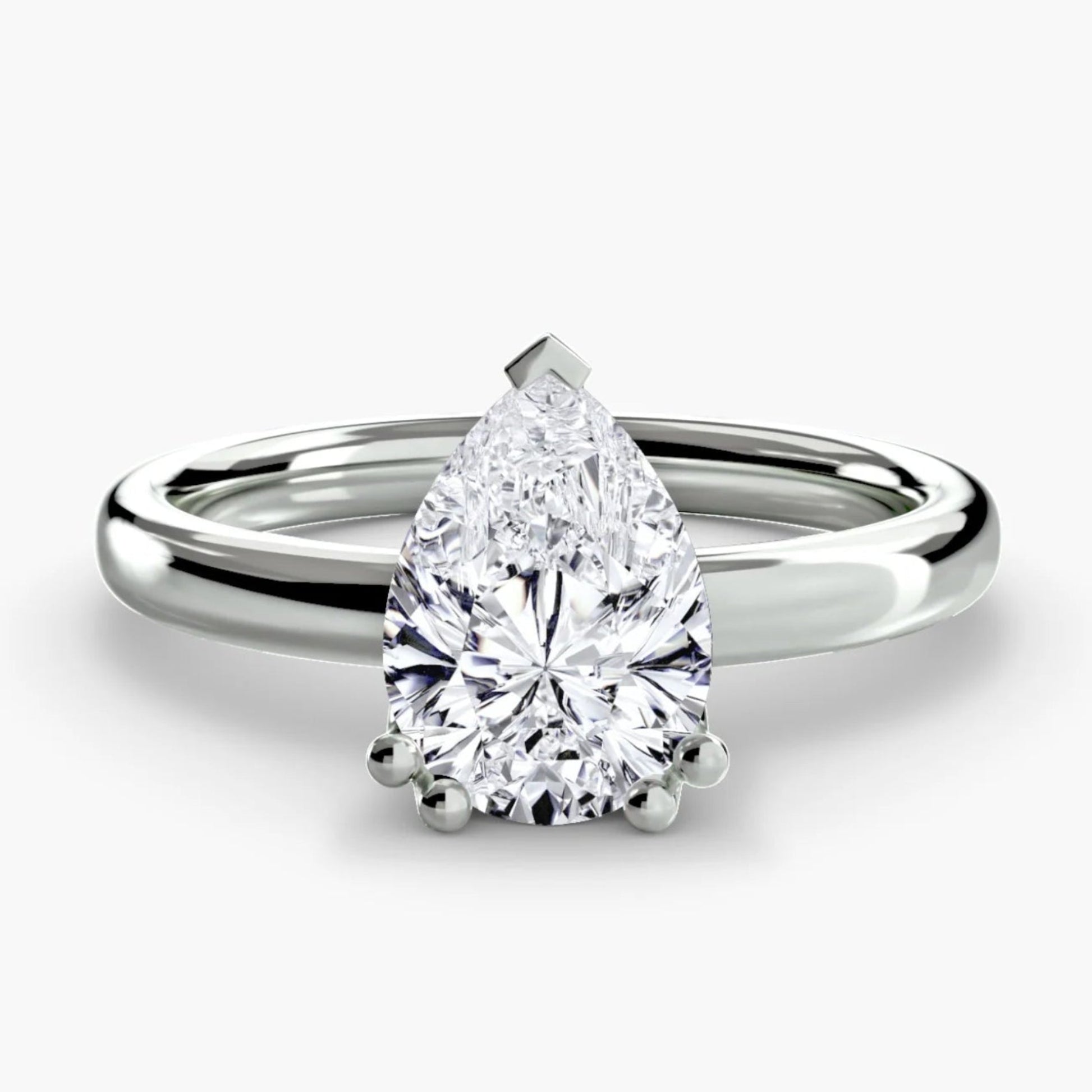 Diamond ring with pear-shaped gemstone on a white background